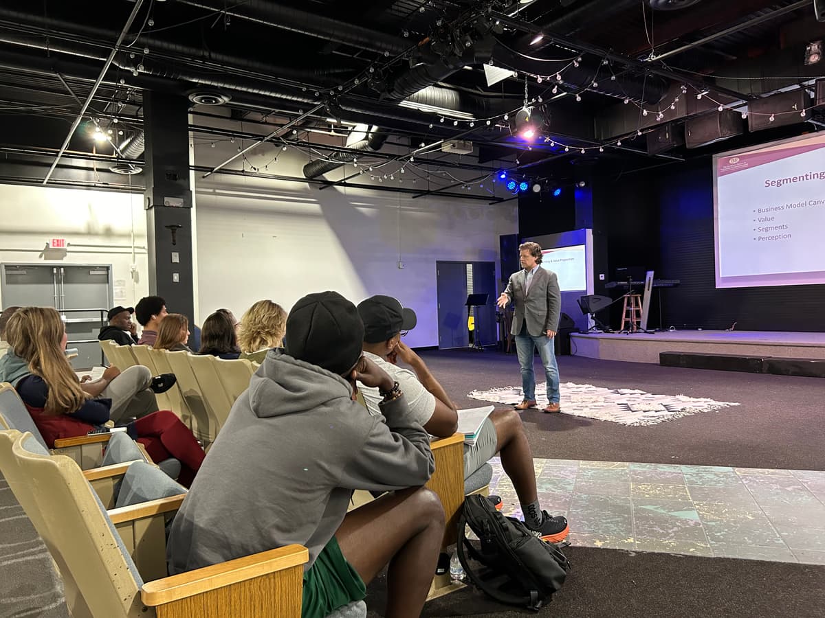 Keynote moment celebrating founders’ milestones at a community event.