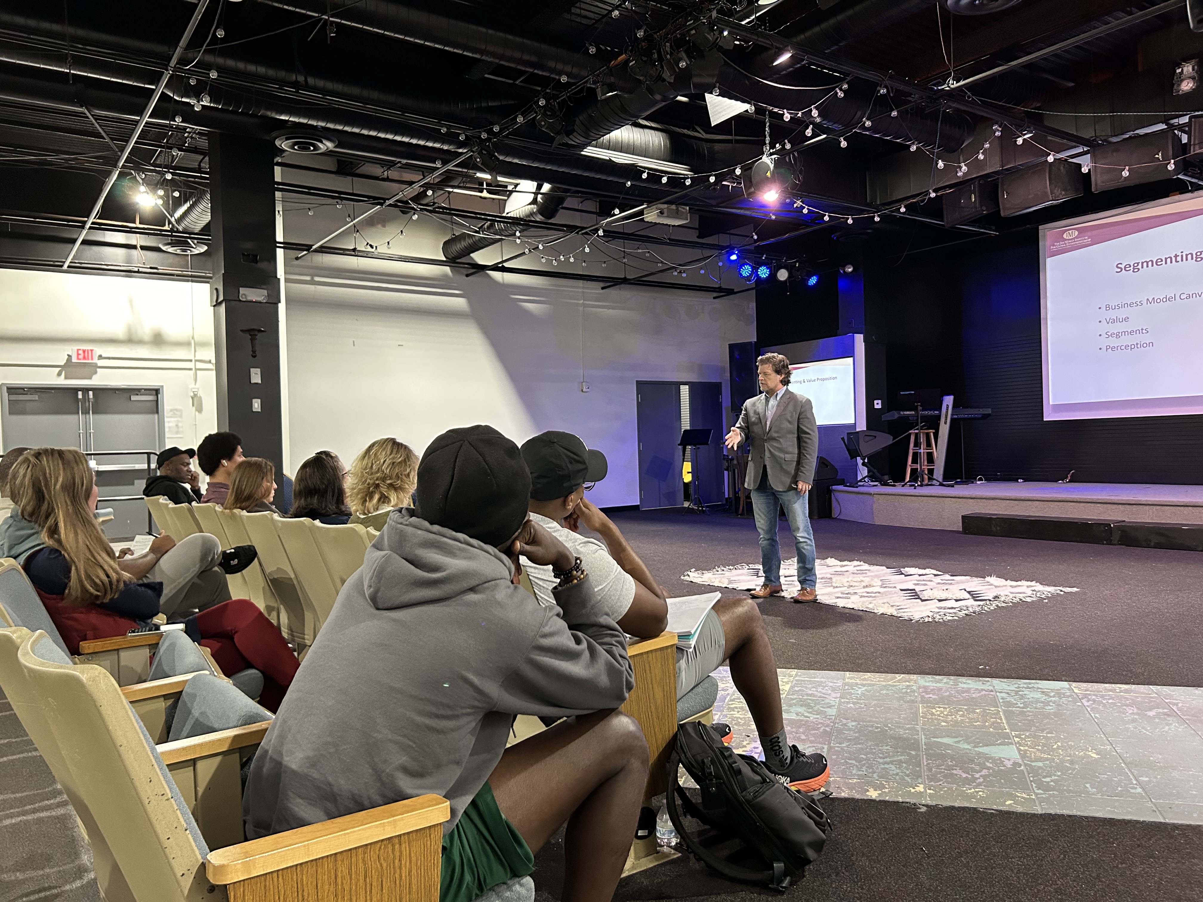 Keynote moment celebrating founders’ milestones at a community event.